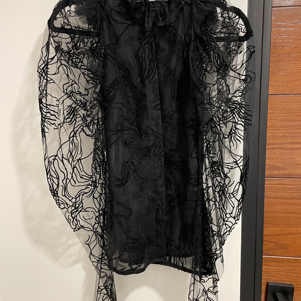 A black blouse with an interior cover tank.